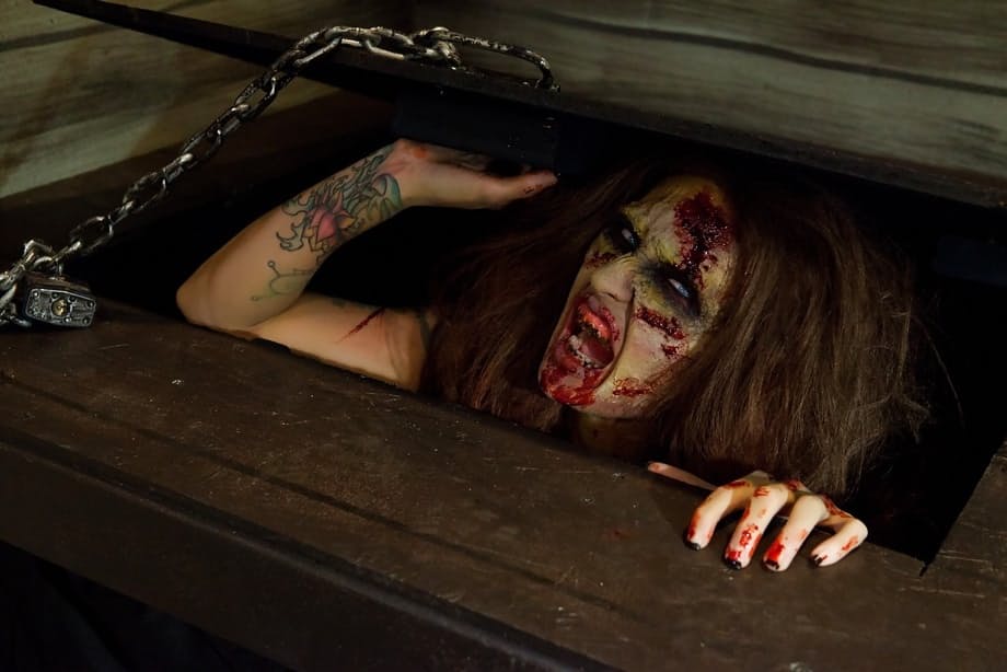 Saucy brunette cosplayer Kleio unveils her zombie tits and pussy