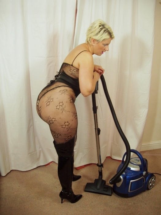 Curvylicious housewife Daniella English vacuuming in fishnets and black boots