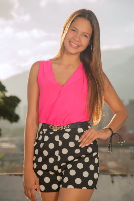 Beautiful young girl Kiara Lorens does a striptease on a patio