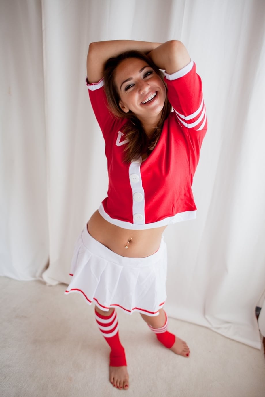 Cute brunette cheerleader flashing young tits and ass in sports socks
