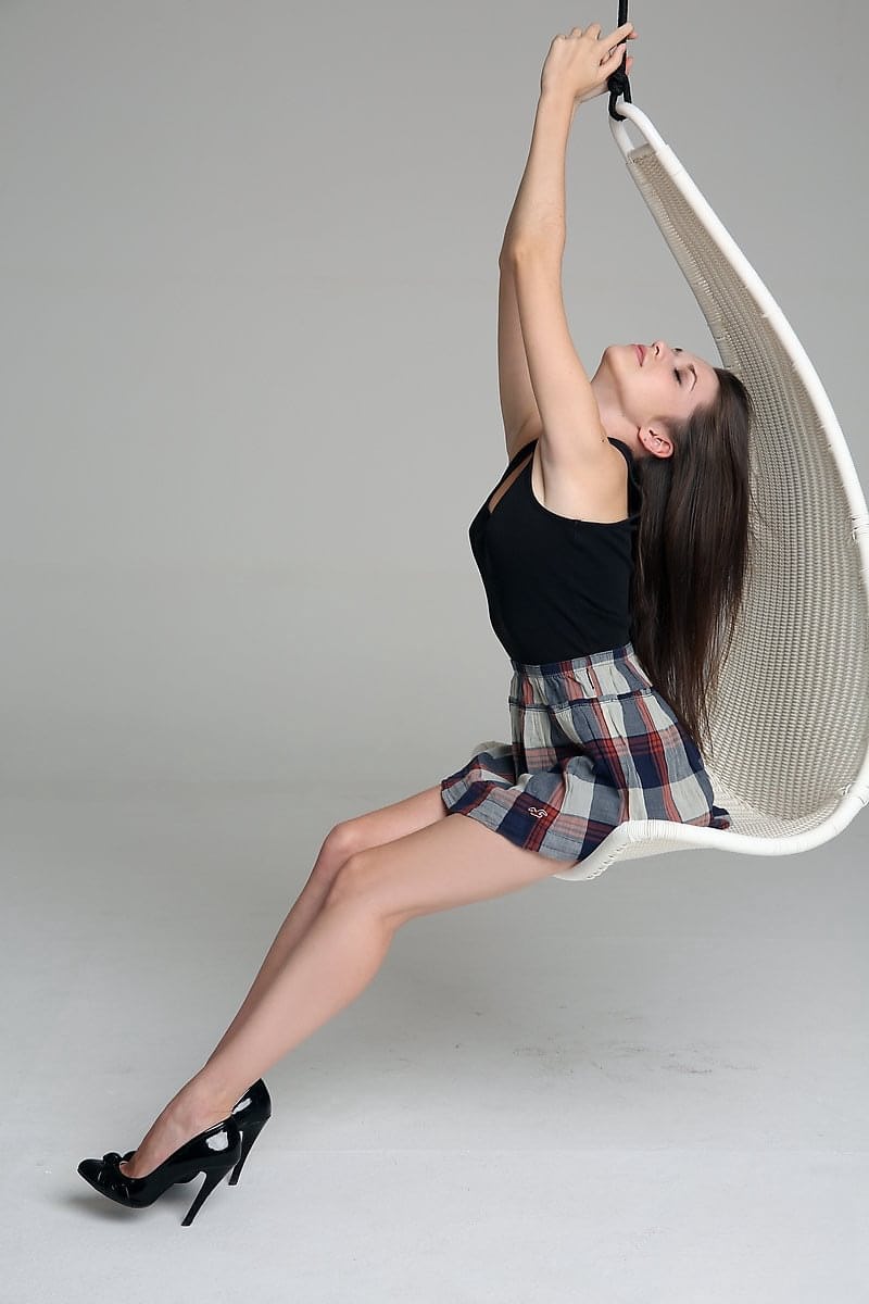 Sexy teen hikes her plaid skirt to expose her clean shaven pussy