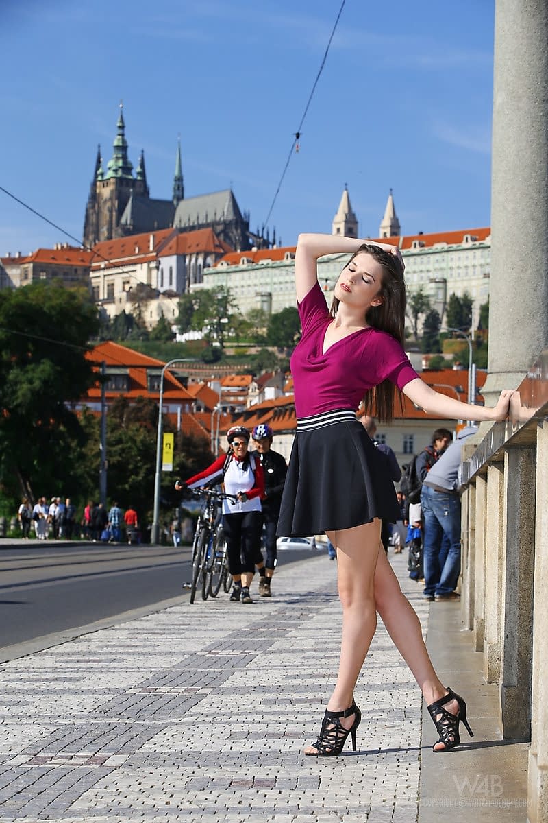Clothed chick shows off her bare legs in a miniskirt and high heels in public