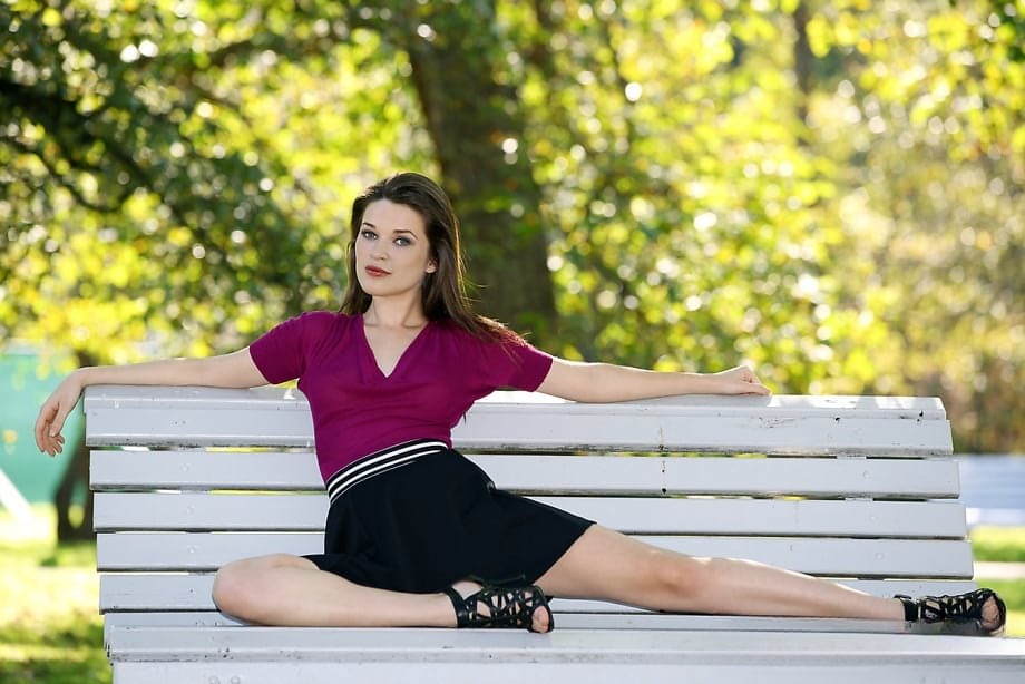 Clothed chick shows off her bare legs in a miniskirt and high heels in public