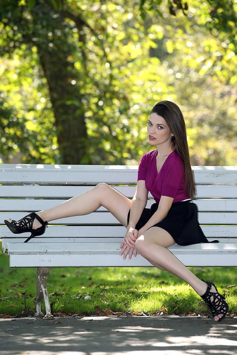 Clothed chick shows off her bare legs in a miniskirt and high heels in public