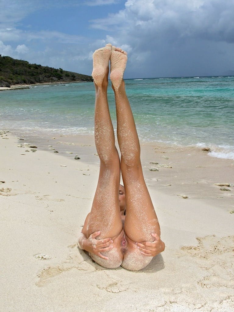 Bikini babe Charlie suns her sandy shaved pussy in hot beach closeup