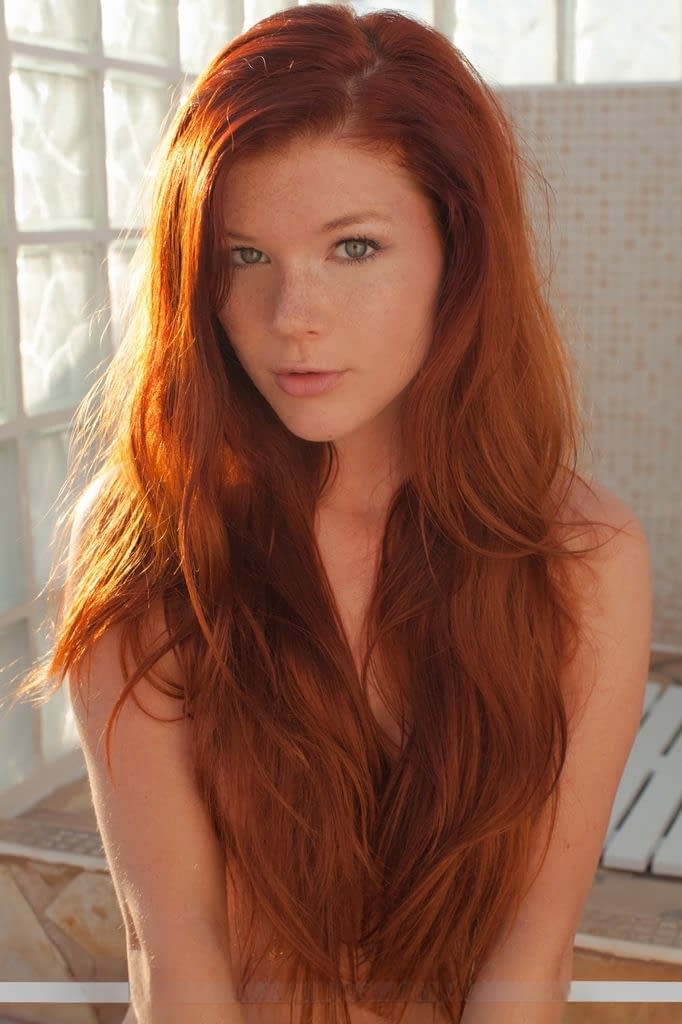 Redhead babe Mia Sollis revealing small teen tits and tight ass outdoors
