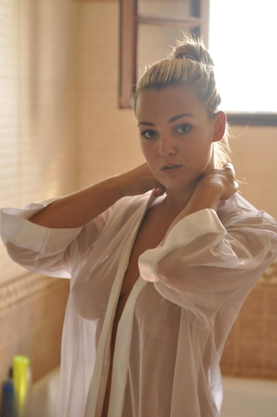 Beautiful blonde chick Jodie Gasson pulls on a see thru blouse in the morning