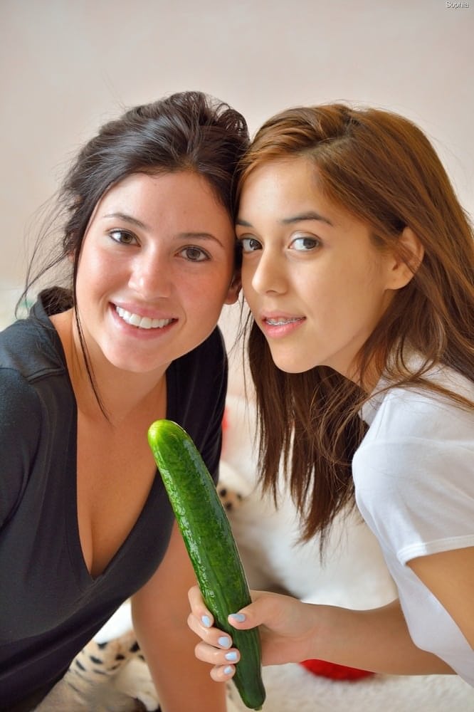 Barely legal lesbians with perky tits insert cucumbers into horny cunts