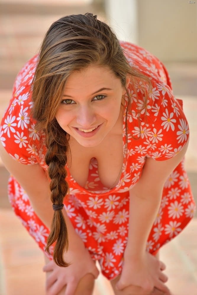 Frisky young girl with braided hair letting ripe tits and twat free outside