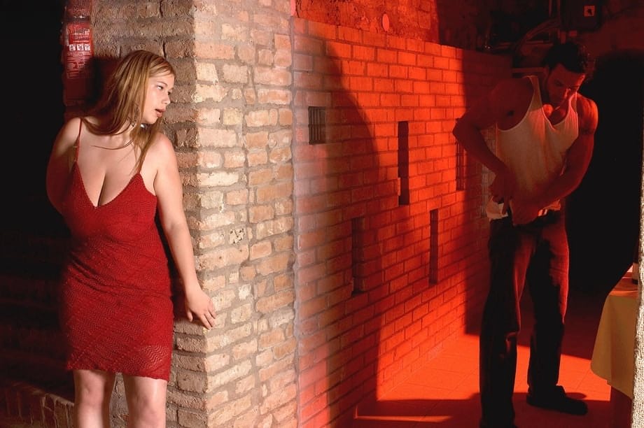 Redhead plumper Terry Nova models non nude in a red dress on cellar stairs