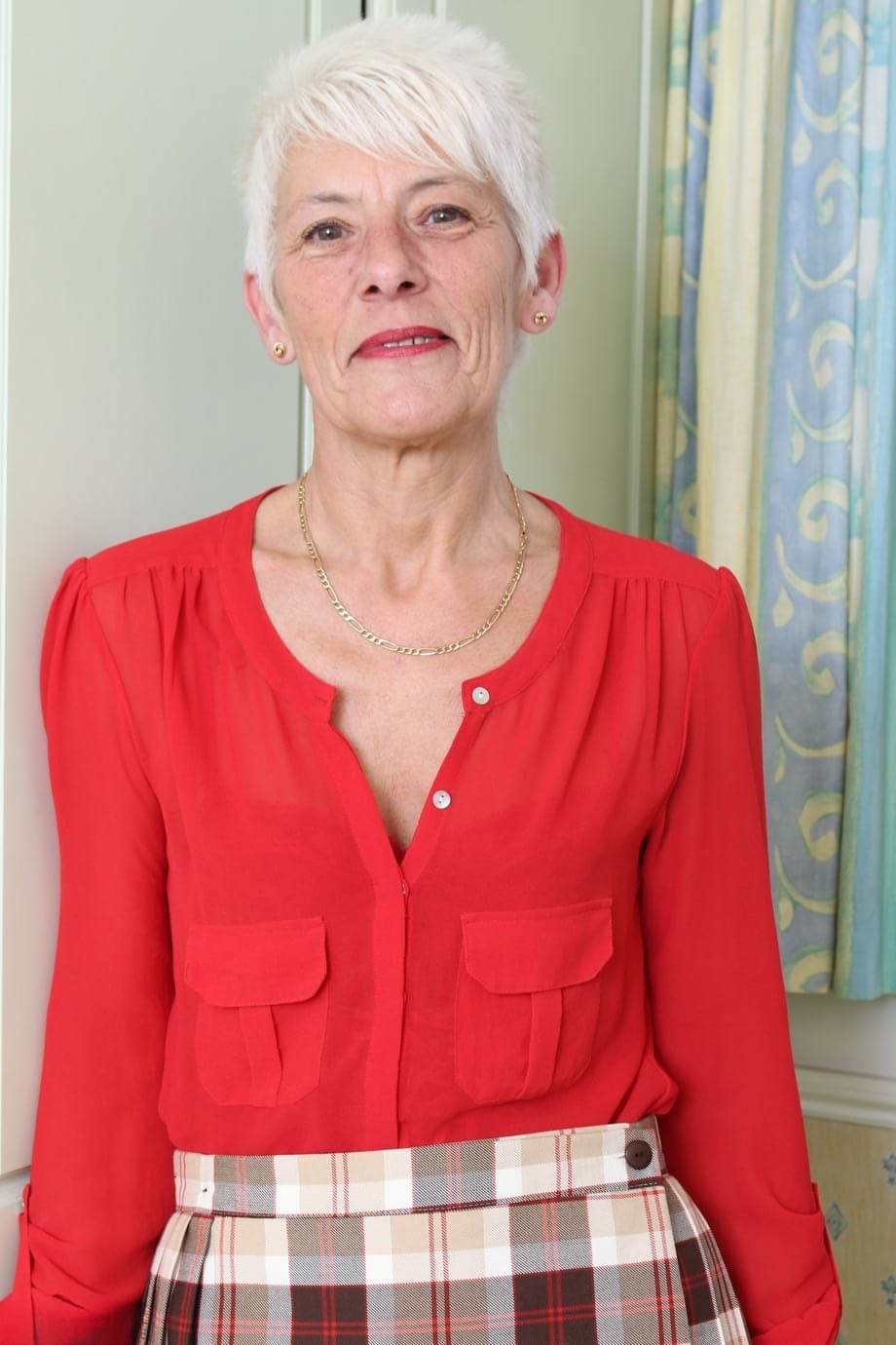 Over 70 Bristish granny takes off her clothes and lingerie striptease style