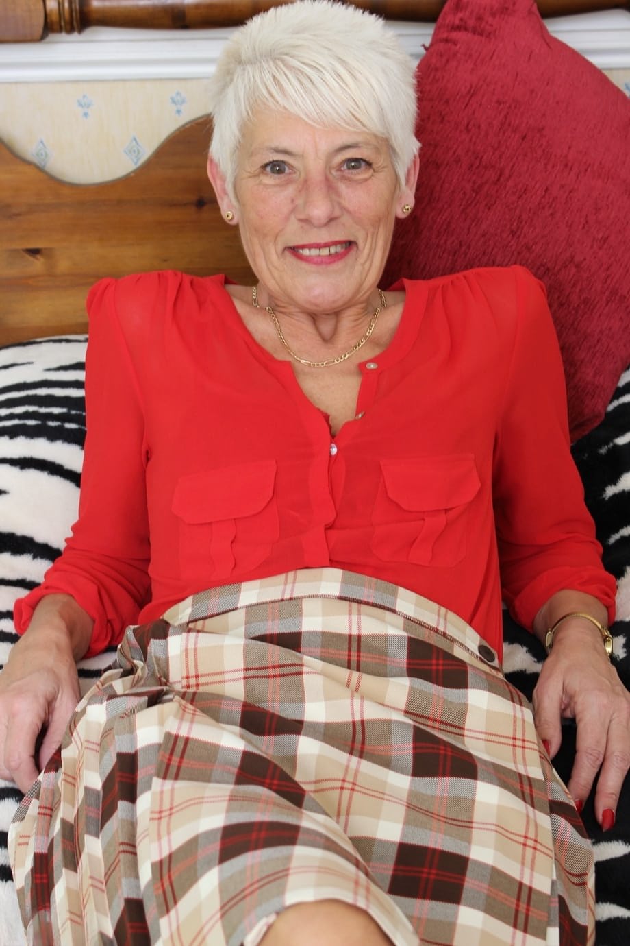 Over 70 Bristish granny takes off her clothes and lingerie striptease style