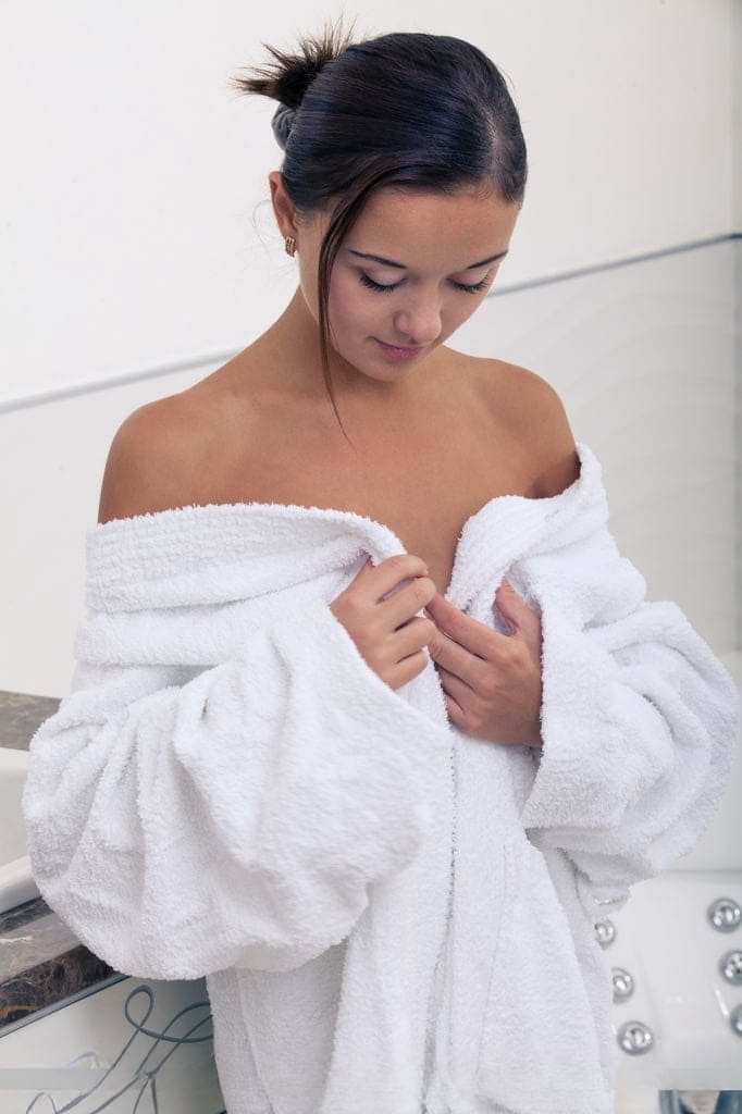 Wet European babe exposing small teen breasts and shaved cunt in bathtub