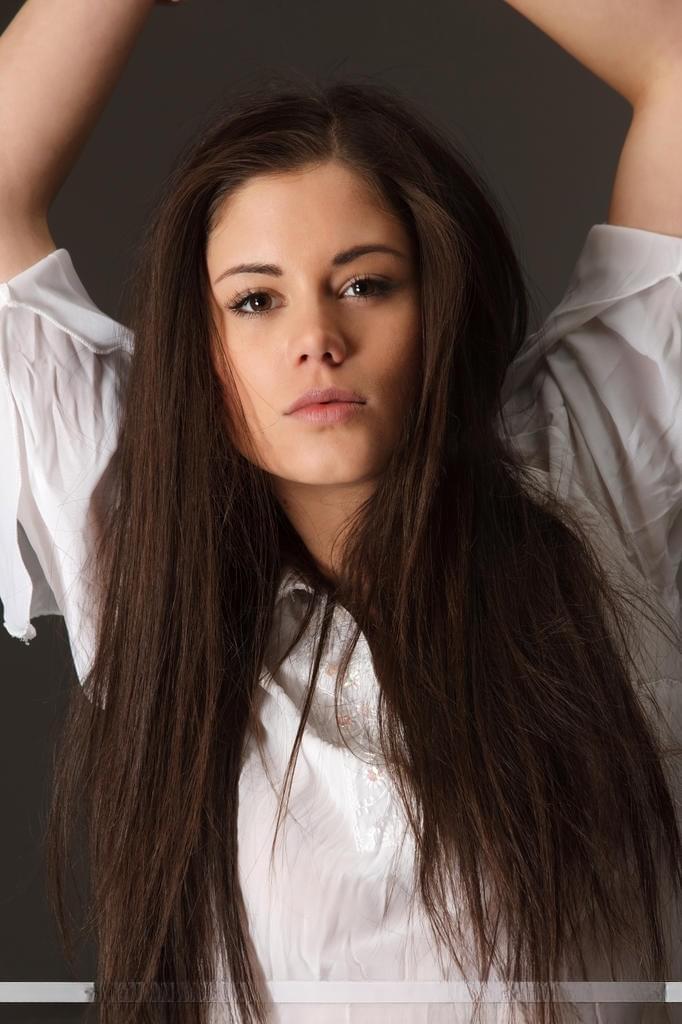 Beautiful teen model Caprice A displaying great legs while stripping naked