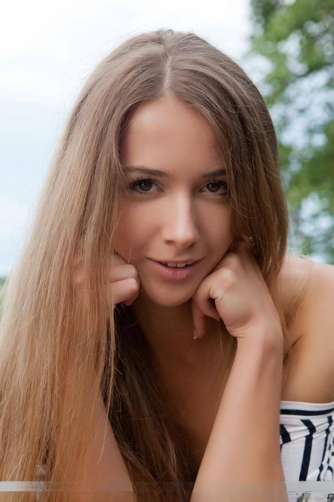Euro babe with beautiful teen face and spread legs displaying shaved pussy
