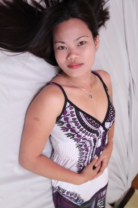 Petite Filipina female spreads her labia lips after getting naked on her bed