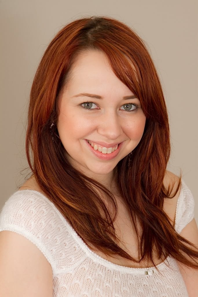 Busty redhead secretary Alisyn Carliene stripping her skirt and panties off
