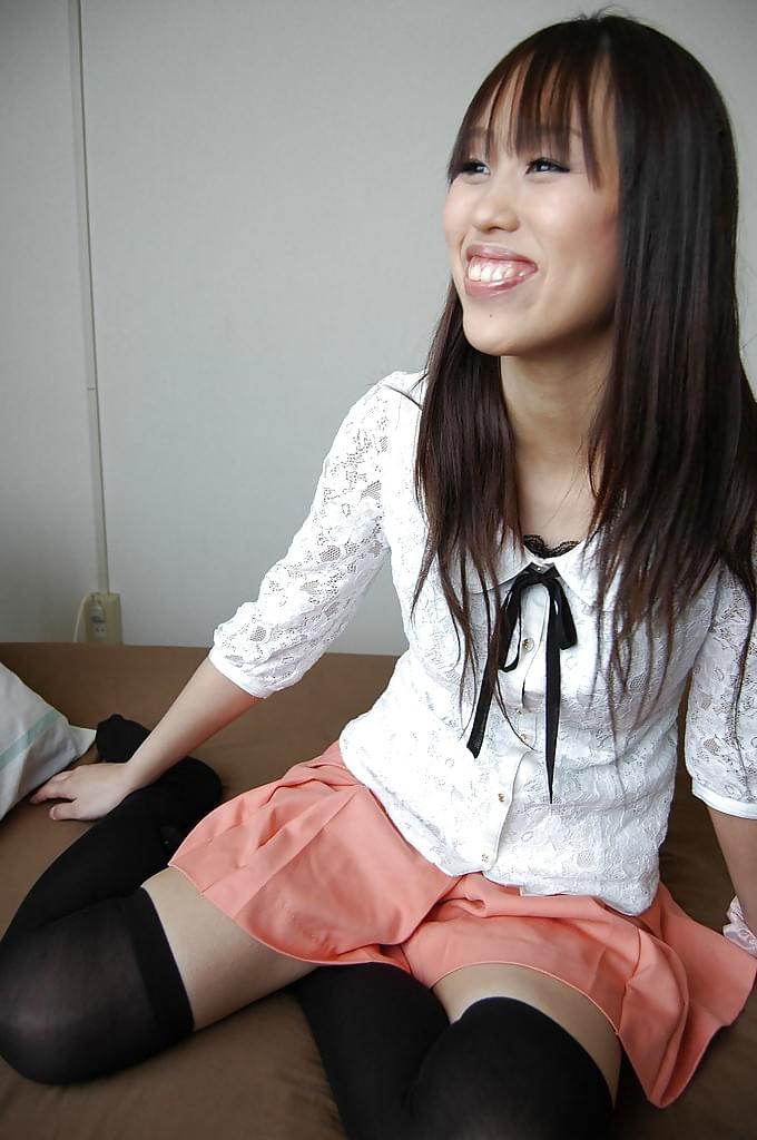 Smiley asian girl getting nude and exposing hairy gash in close up
