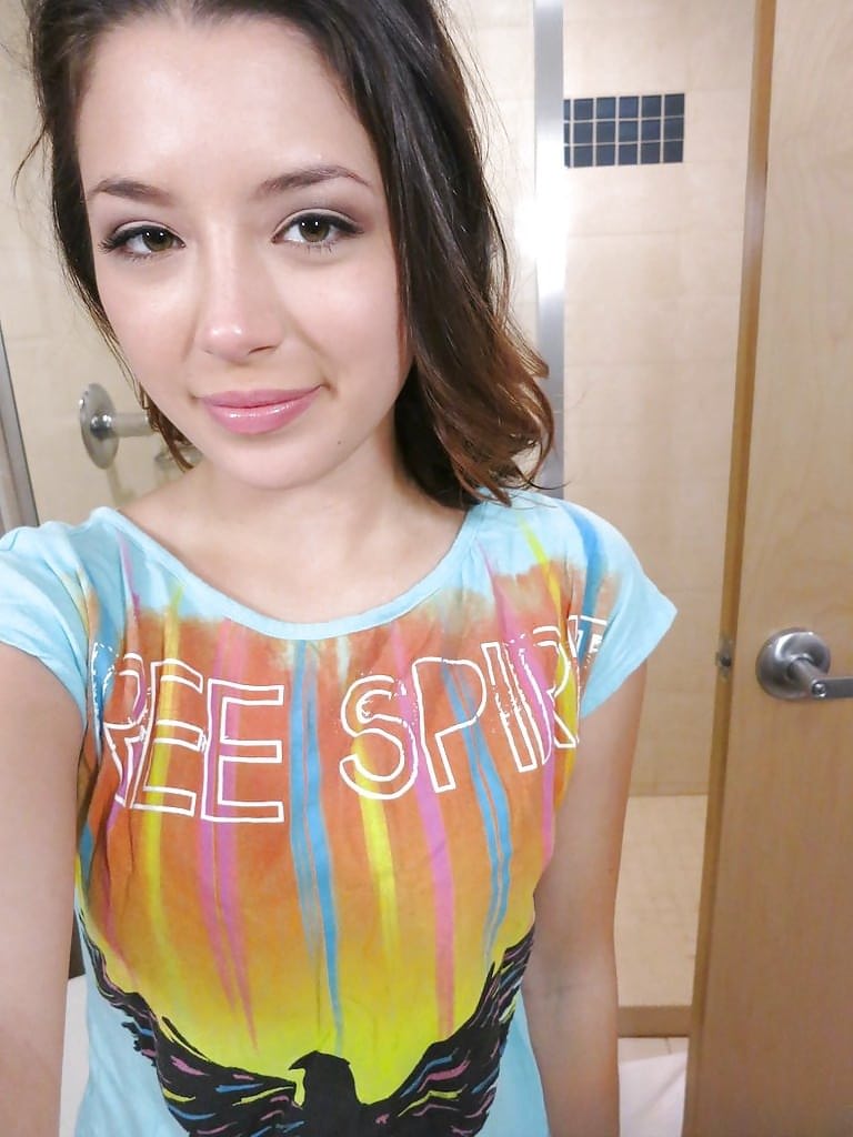 Alluring cutie revealing her titties and teasing her honey pot