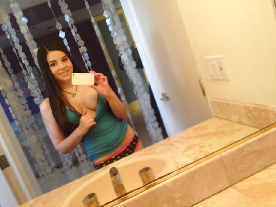 Loveable latina cutie undressing and making selfies in the bathroom
