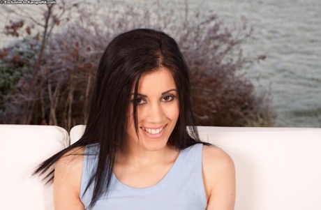 Pretty black eyed and black haired teen presents her nice holes