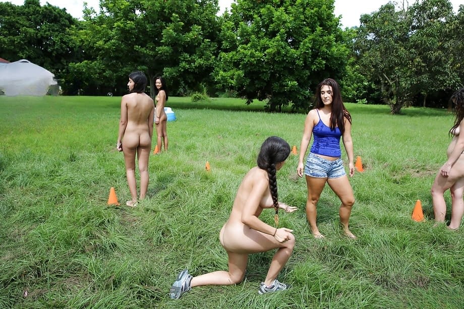 Pretty naked lesbians are standing naked and showing their bodies outdoors