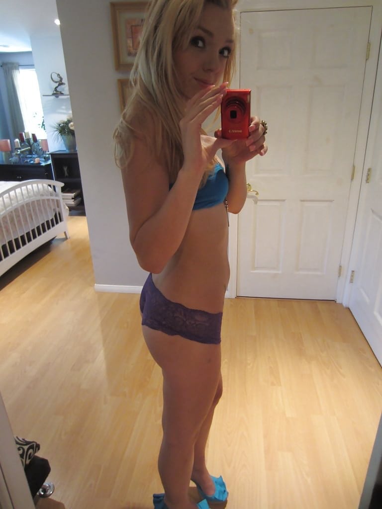 Ally Winters is spreading her slim legs wide open while masturbating