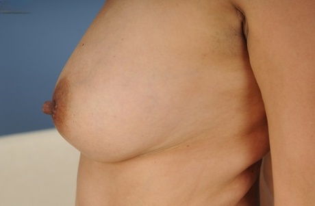Busty mommy Estella Eves is posing naked and playing very hot