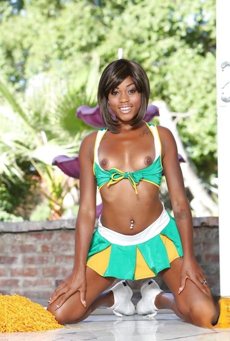 Black cheerleader Karma May shows off her big dark ass and tits