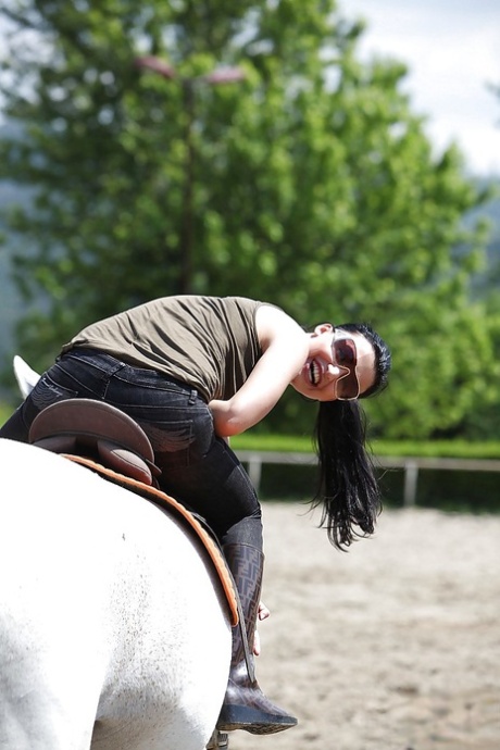 Pornstar Aletta Ocean is riding a horse outdoor in glasses