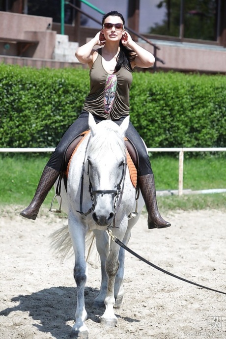 Pornstar Aletta Ocean is riding a horse outdoor in glasses
