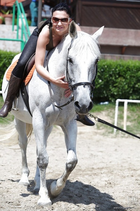 Pornstar Aletta Ocean is riding a horse outdoor in glasses
