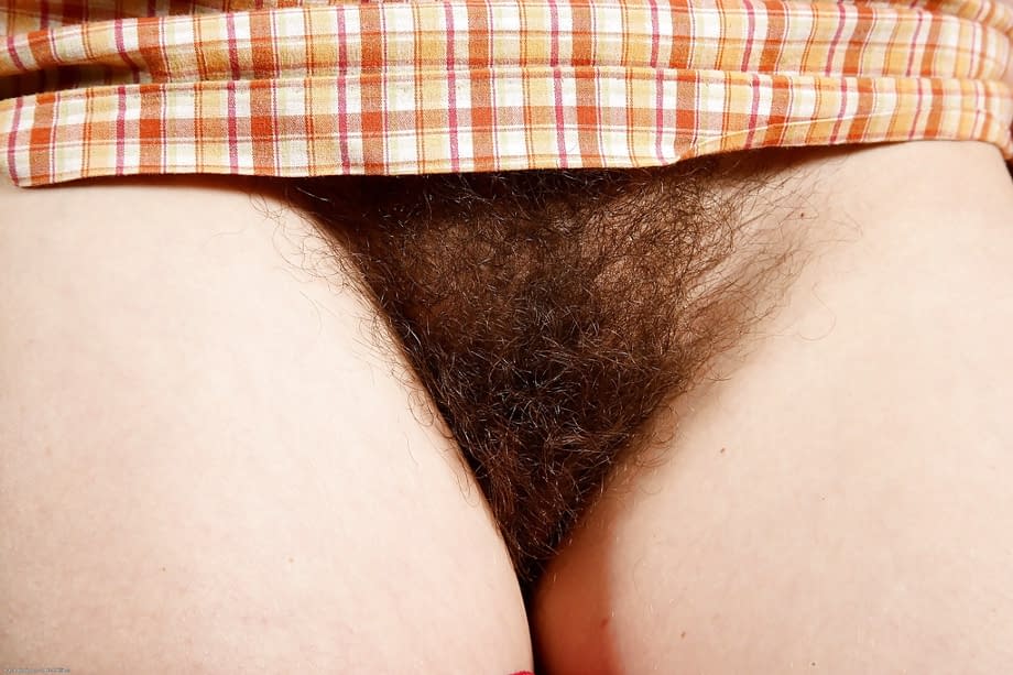 Mature brunette Sunshine spreads her legs to reveal hairy bush