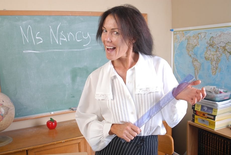 Naughty granny Nancy gets completely naked in the school room