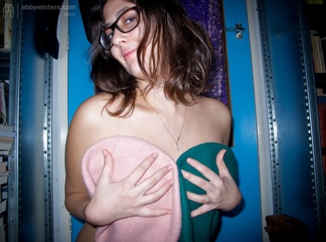 Young fatty Ariel D poses in glasses while flashing large natural tits