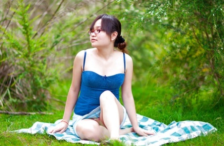 Hairy Asian amateur Gita slowly taking off her clothes outdoors