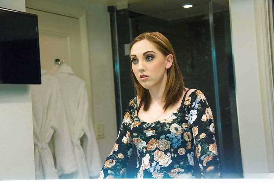 Young escort Nickey Huntsman dressing for evening's work as prostitute