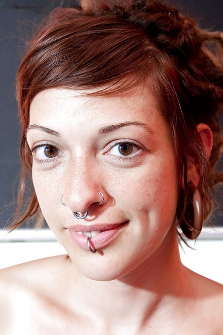 Amateur redhead Monika removes brassiere to expose small tits