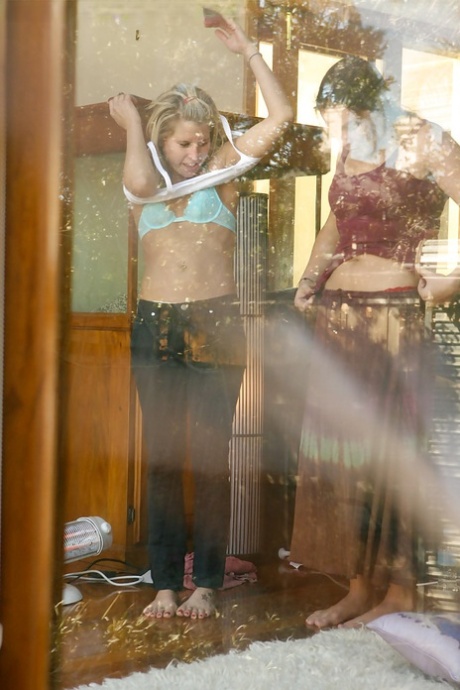 A Peeping Tom stands outside bedroom window while two girls get dressed