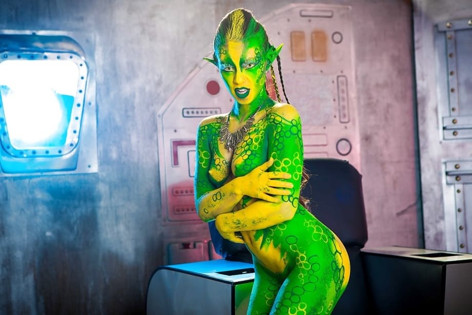 Kinky cosplay chick Tiffany Doll posing in body paint uniform and spreading