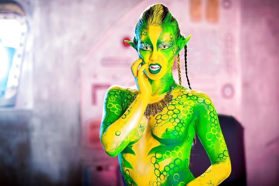 Kinky cosplay chick Tiffany Doll posing in body paint uniform and spreading