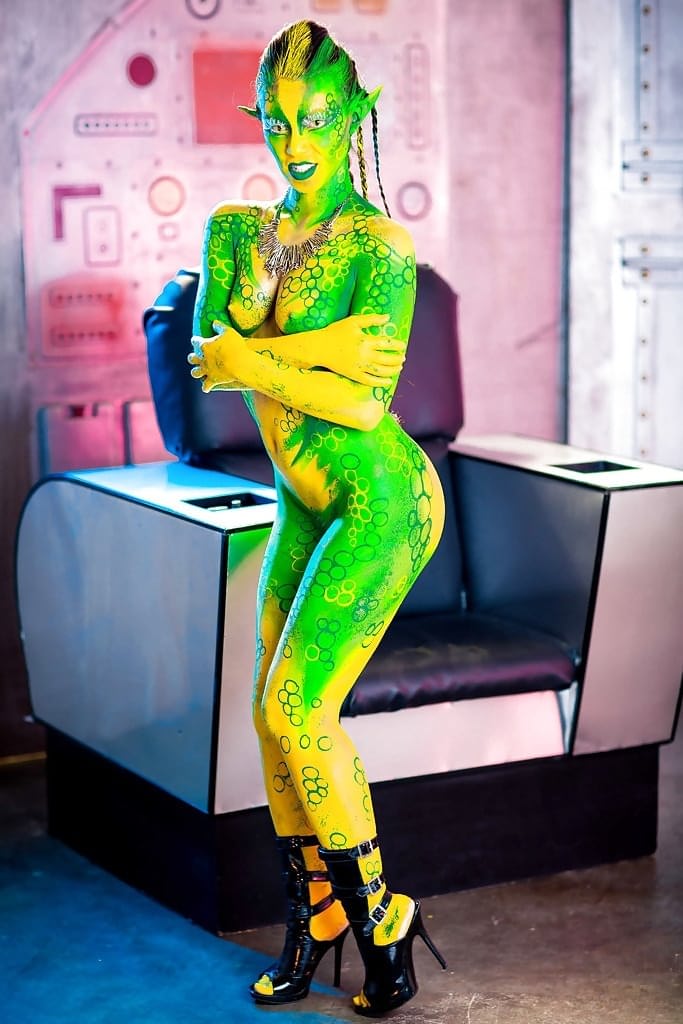 Kinky cosplay chick Tiffany Doll posing in body paint uniform and spreading