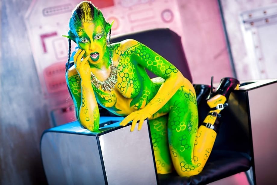 Kinky cosplay chick Tiffany Doll posing in body paint uniform and spreading