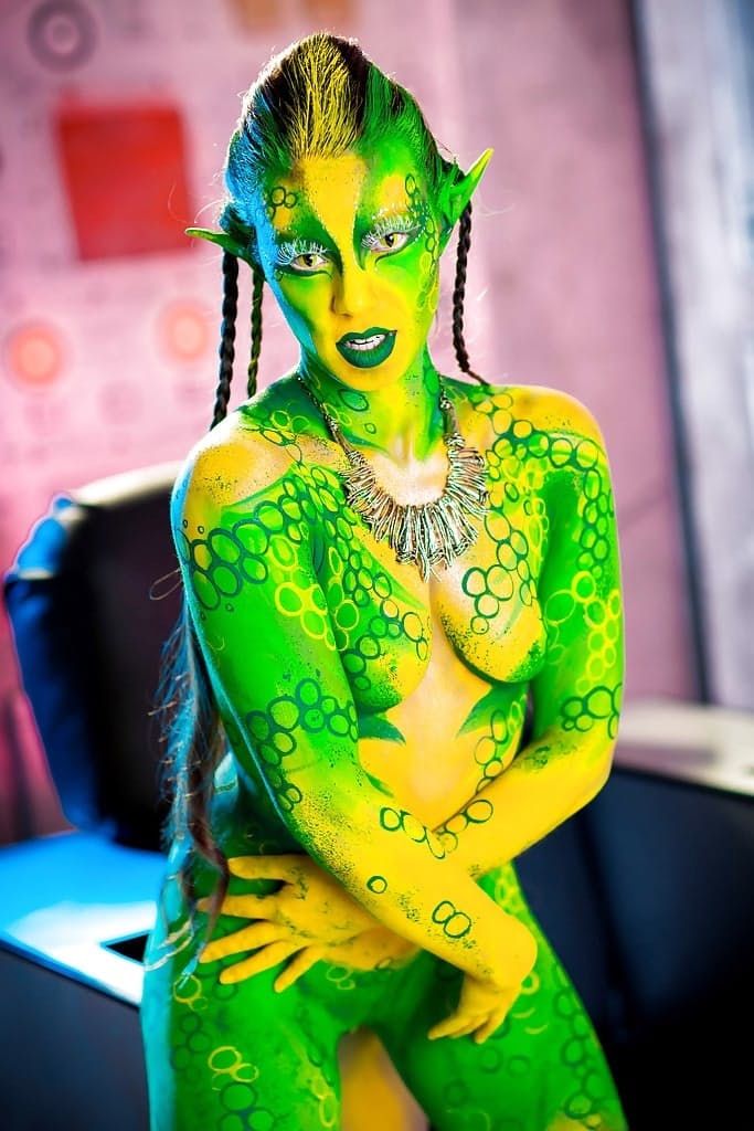 Kinky cosplay chick Tiffany Doll posing in body paint uniform and spreading
