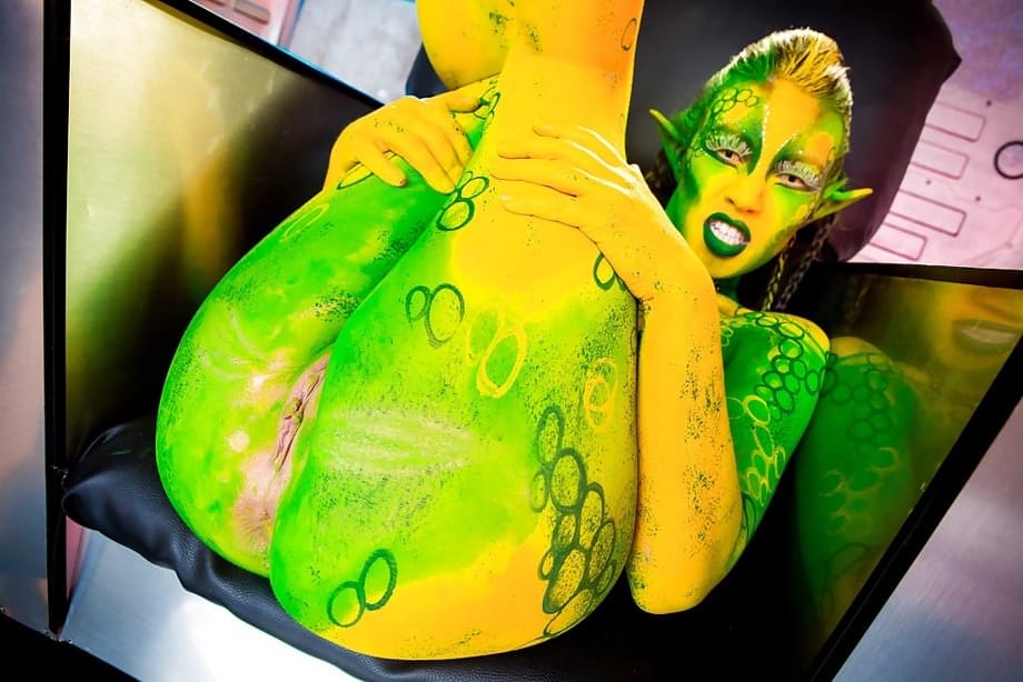Kinky cosplay chick Tiffany Doll posing in body paint uniform and spreading
