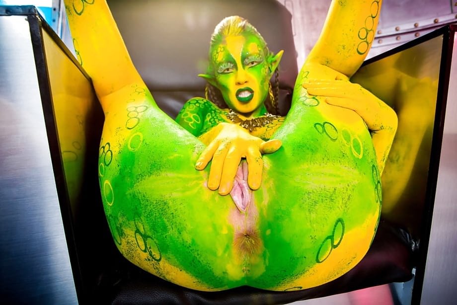 Kinky cosplay chick Tiffany Doll posing in body paint uniform and spreading