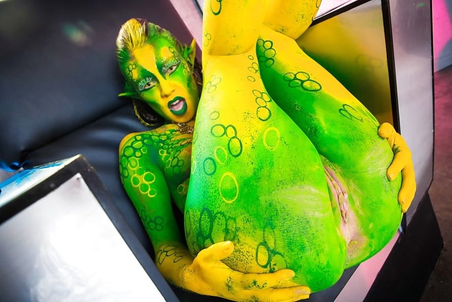 Kinky cosplay chick Tiffany Doll posing in body paint uniform and spreading