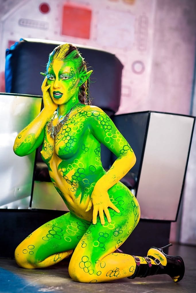 Kinky cosplay chick Tiffany Doll posing in body paint uniform and spreading