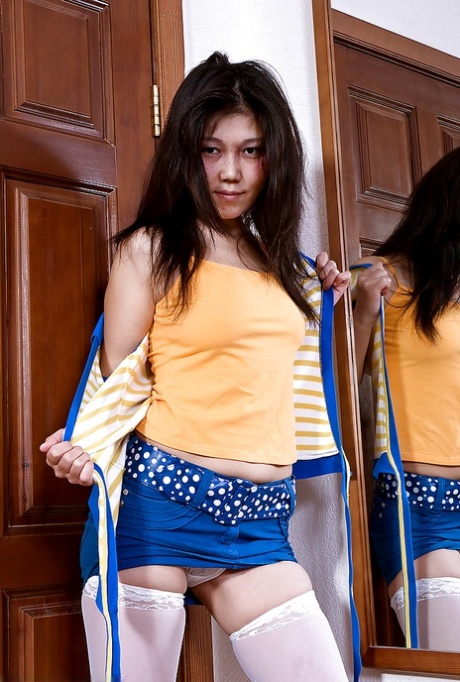 Japanese amateur Aksana posing seductively in white stockings and boots