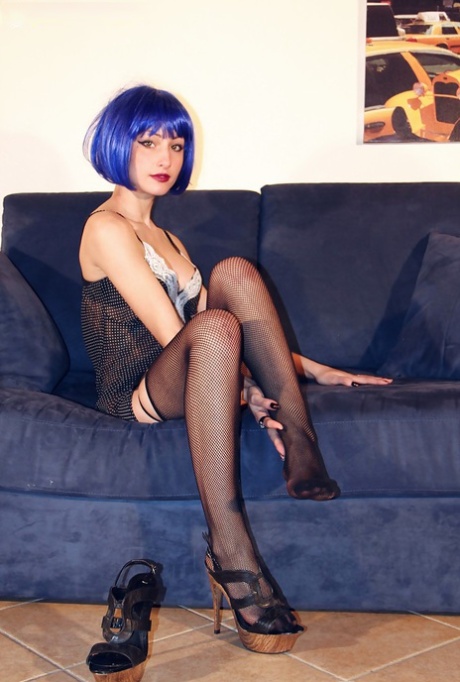Blue haired alt babe Thena striking sexy poses in black nylons and garters